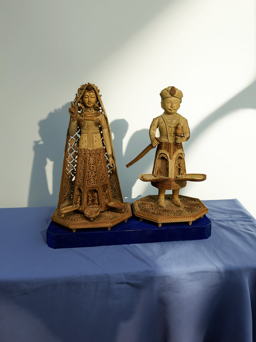 Shop the graceful Sandalwood Carvings of Raja Rani Ray's Ancient Tales on Wood.
