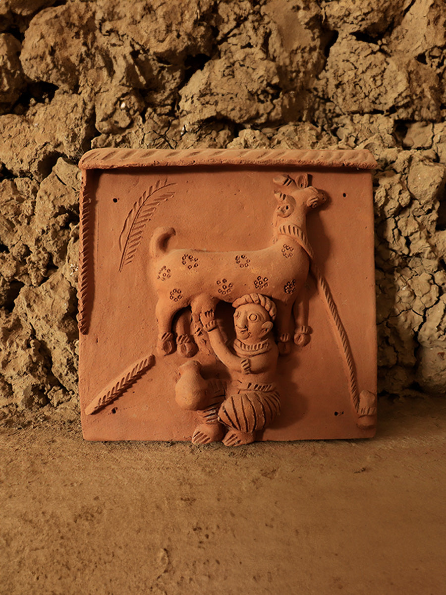 Representation of a man milking goat: Terracotta by Dinesh Molela