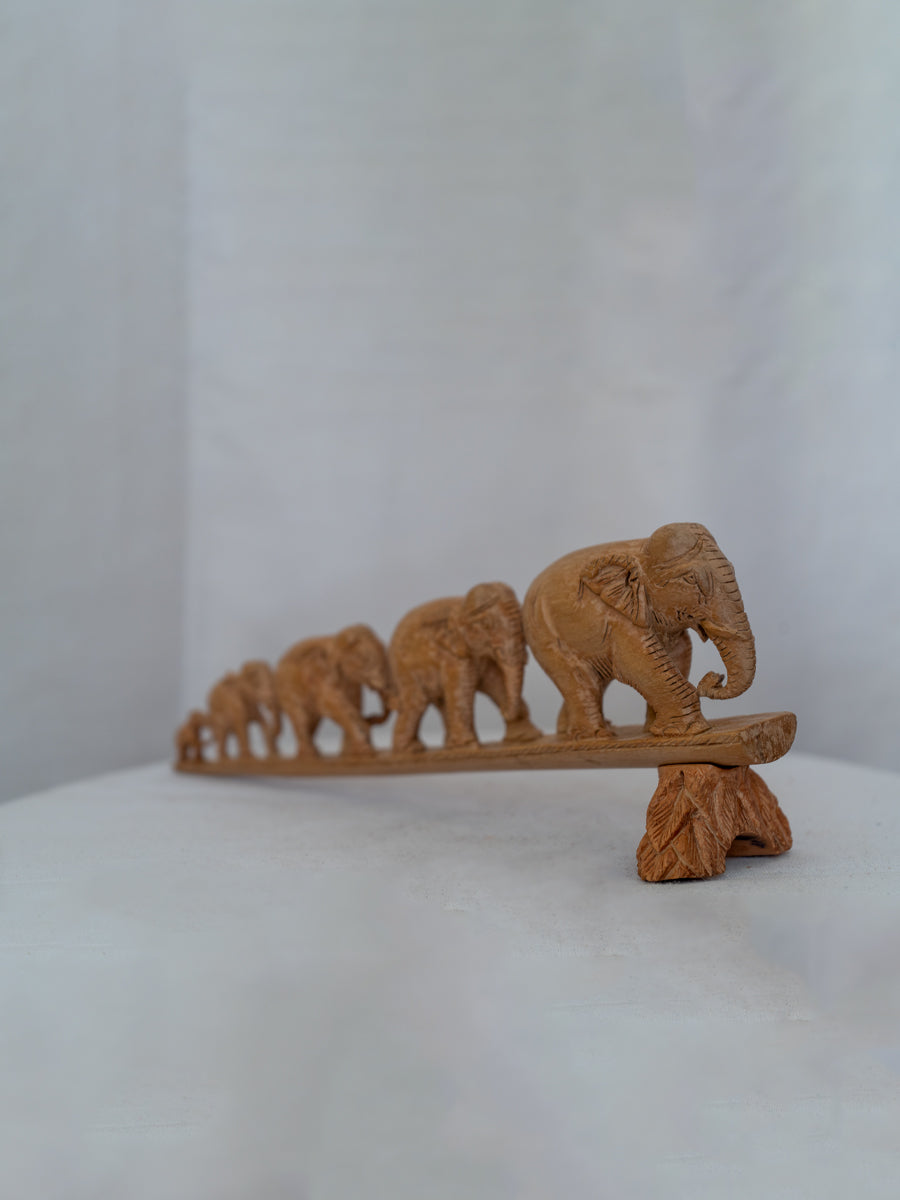 Obtain "March of Wisdom," a captivating wooden carving depicting a unified journey. Purchase this masterpiece now.