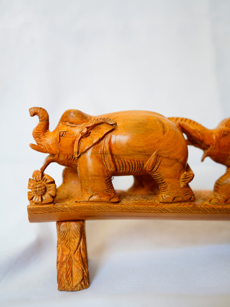 Experience the Elephant Convergence: A Wooden Carving Bound by Trunks. Shop now and embrace its artistic beauty.
