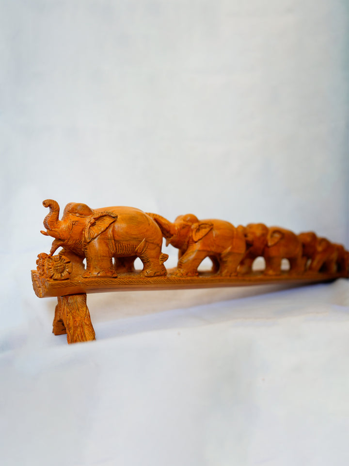Elephant Convergence: A Wooden Carving Bound by Trunks by Ajit Kumar Thumbnail