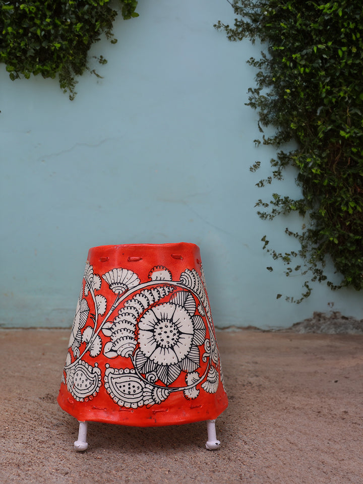 Crimson Blossoms: Intricacy on vibrant background Tholu lamps by Kanday Anjanappa Thumbnail