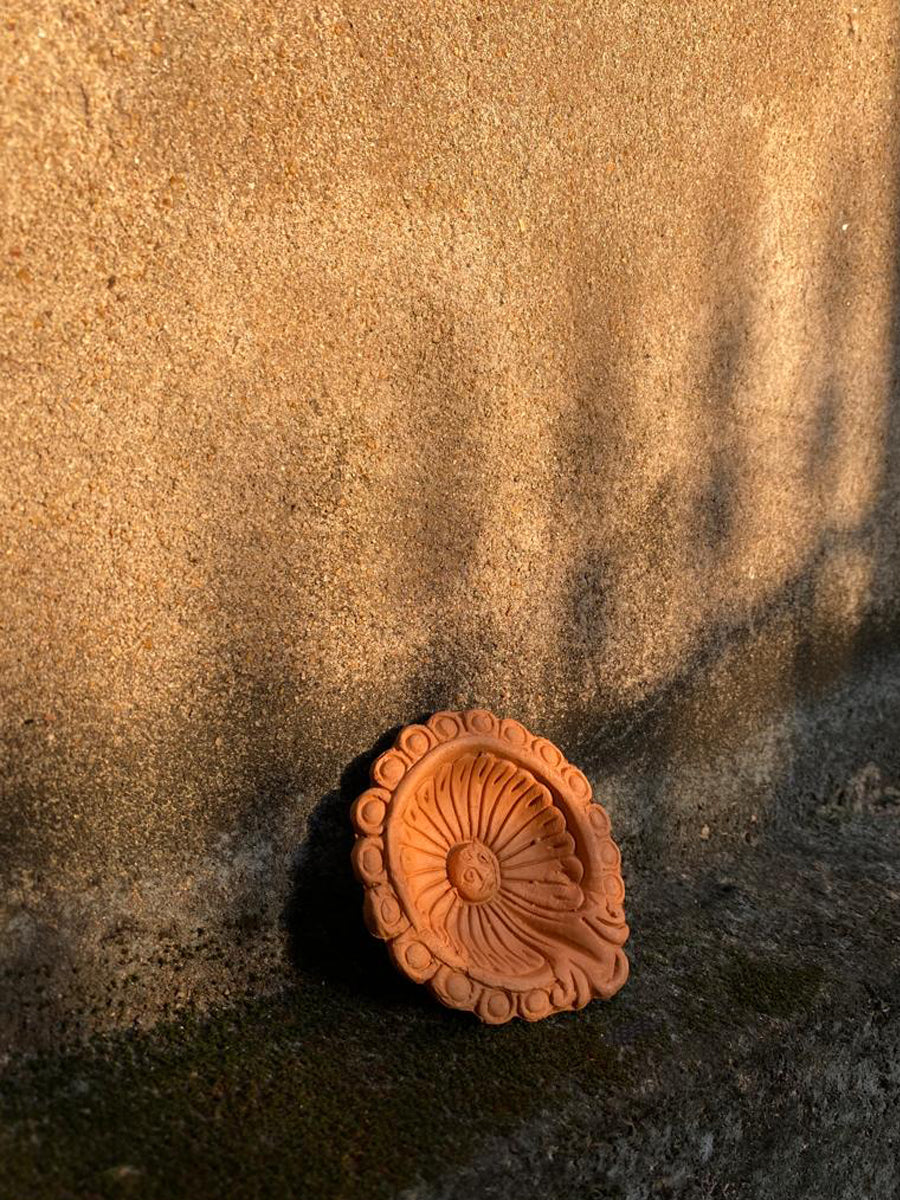 Buy Circular diya with sun pattern: Terracotta Diya by Dolon Kundu