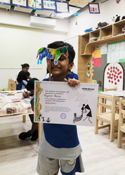 Student with his artwork and certificate