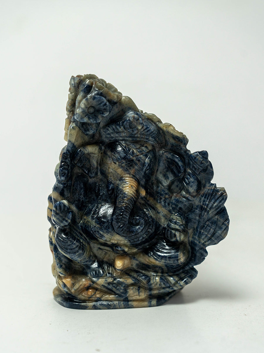 Wisdom's Reflection: Blue Sapphire Ganesha with the Graceful Peacock