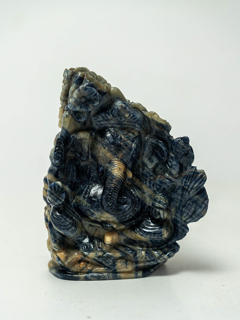 Wisdom's Reflection: Blue Sapphire Ganesha with the Graceful Peacock